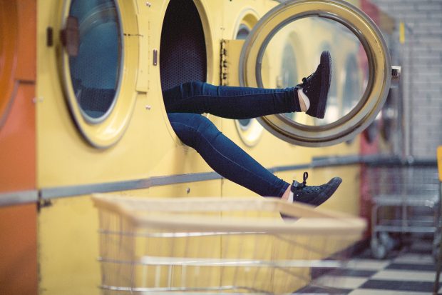 Legs sticking out of a washing mashine