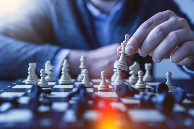 Man holding a chess piece